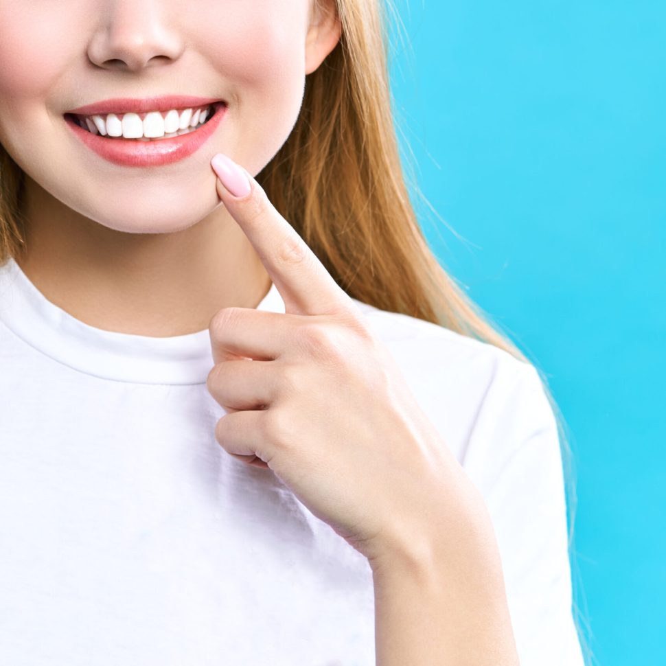 Perfect healthy teeth smile of a young woman. Teeth whitening. Dental clinic patient. Image symbolizes oral care dentistry, stomatology
